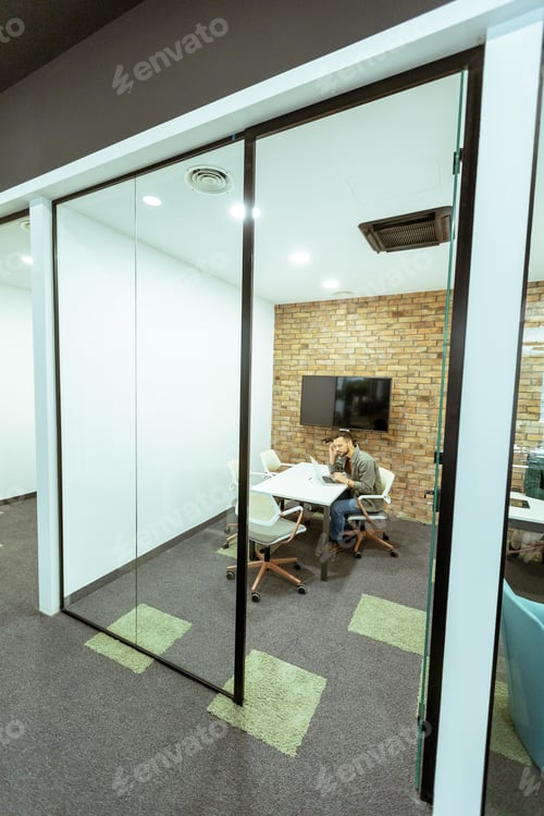 Preview: Focused work in a modern glass-walled office