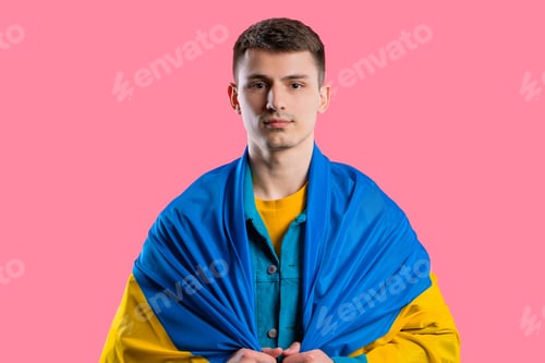 Preview: Smiling young man with national Ukrainian flag. Ukraine, patriot, victory in war