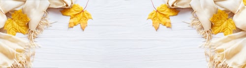 Preview: autumn leaves with a scarf on a wooden background with copy space. banner