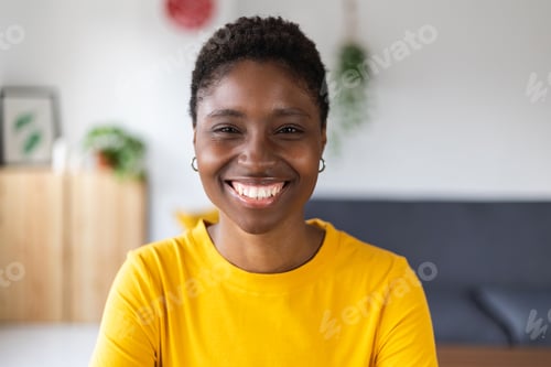 Preview: Portrait screen view of smiling millennial african woman on video call at home