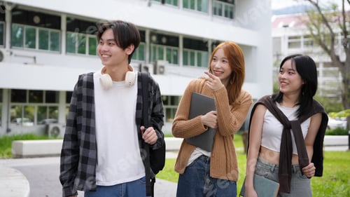 Preview: Three youthful individuals having a great time together on a contemporary college campus