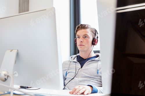 Preview: Young male computer aided designer working on computer in design studio