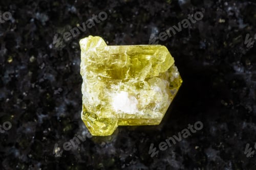 Preview: sample of raw chrysoberyl mineral on black granite