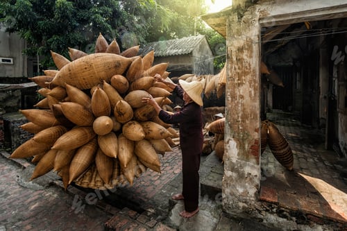 Preview: Old Vietnamese male craftsman standing with bicycle which making the traditional bamboo fish
