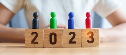 Preview: Colorful wooden people with 2023 Year blocks on table