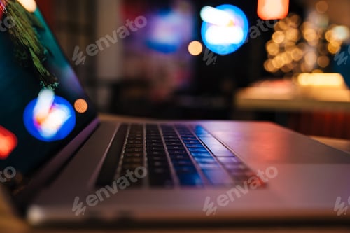 Preview: Photo of qualitative modern laptop with neon reflections