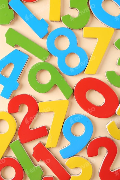 Preview: Colorful numbers on beige background, flat lay