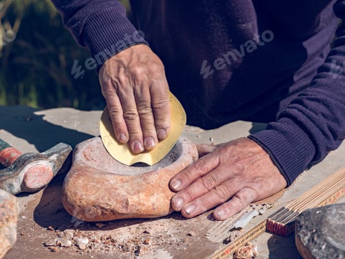 Preview: Crop craftsman processing stone in workshop