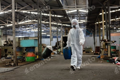 Preview: Chemical inspector female worker wearing protective mask and hazmat suit examining chemistry.