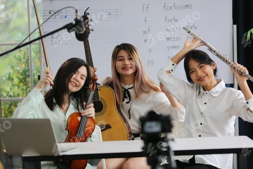 Preview: Young women musician is online training lesson classes playing guitar at home and play music.