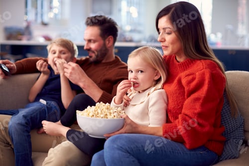 Preview: Family Sitting On Sofa With Popcorn Watching TV Together