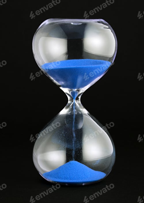 Preview: Close-up of a transparent hourglass with blue sand