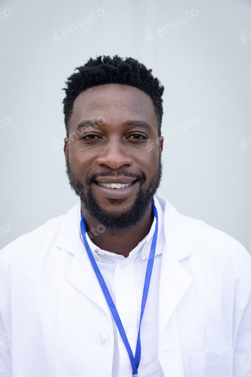 Preview: Portrait of male health professional against grey background
