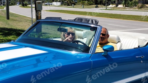 Preview: Couple drive a blue antique automobile to a car show as a muscle car in young at heart.