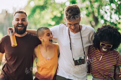 Preview: Portrait of few multiracial friends hugging and walking in a park.