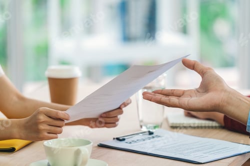 Preview: Closeup Young Asian woman graduate hand holding and Submitting the resume