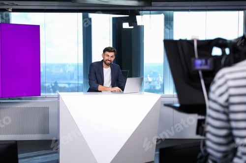 Preview: Presenter and video camera operator working in studio. News broadcasting