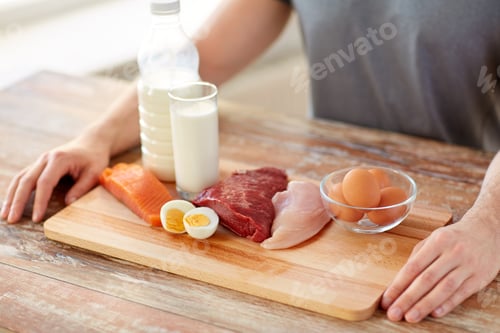 Preview: close up of man with food rich in protein on table