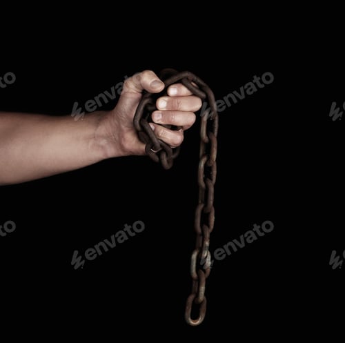 Preview: Adult man in black clothes holds a brown rusty chain in his hand