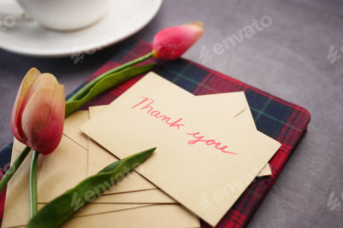 Preview: thank you message, envelope tulip flower on table