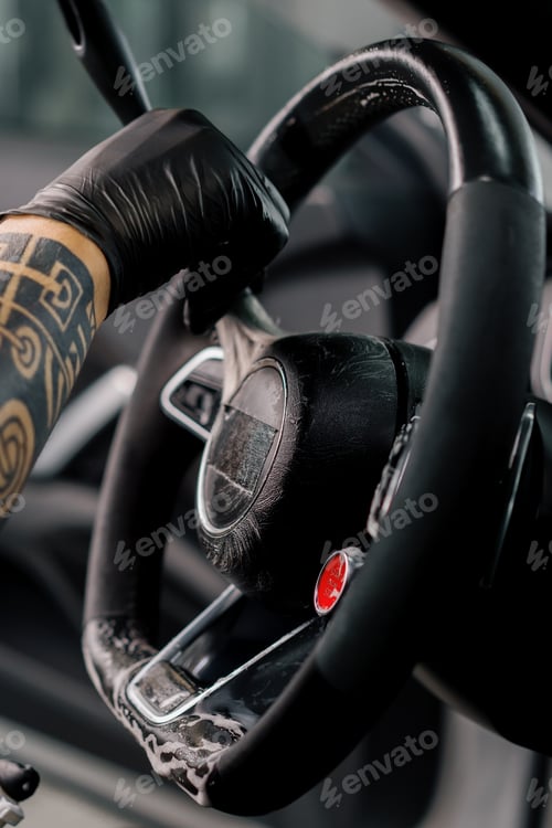 Preview: Worker cleans steering wheel professional brush and clout of microfiber detailing