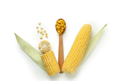 Preview: Spoon with corn seeds and corn on white background