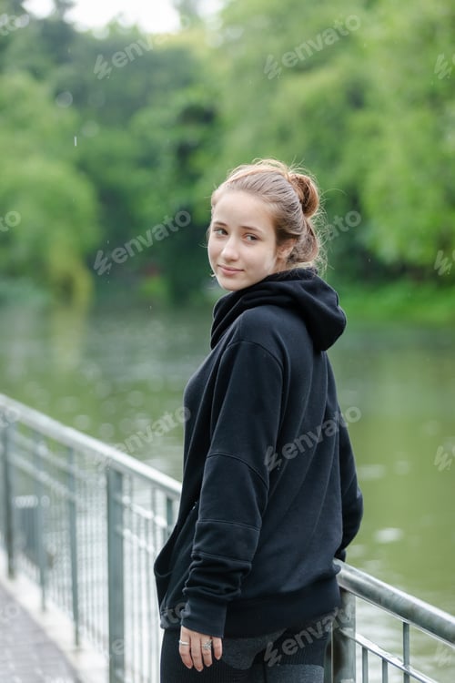 Preview: Portrait of young beautiful female blond hair in black coach jacket