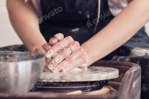 Preview: female make dishes from clay. woman hands working on potters wheel.