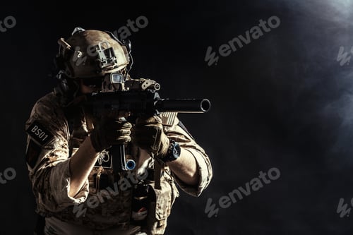 Preview: Soldier aims weapon while using advanced technology for 5G internet communication