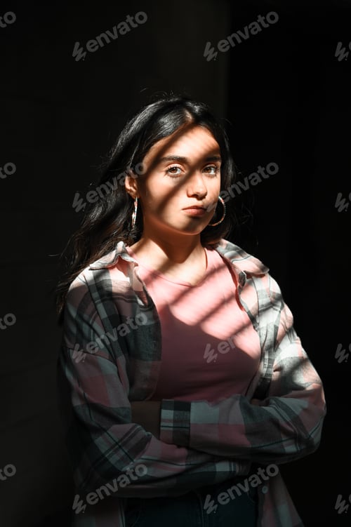 Preview: Confident teenager standing under sunlight