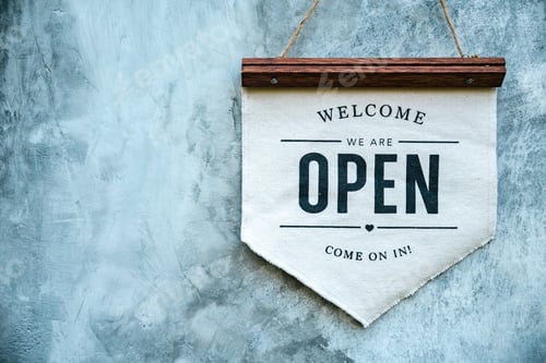 Preview: Hand of coffee shop staff woman wearing apron turning open sign board on glass door