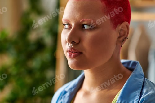 Preview: A thoughtful young woman with vibrant red hair reflecting on her day at home