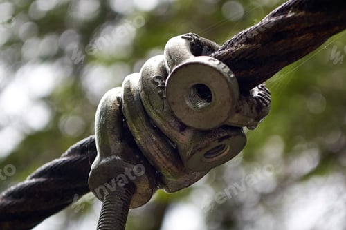 Preview: Metal rings with thread on cable and threaded stud, close-up of steel cable