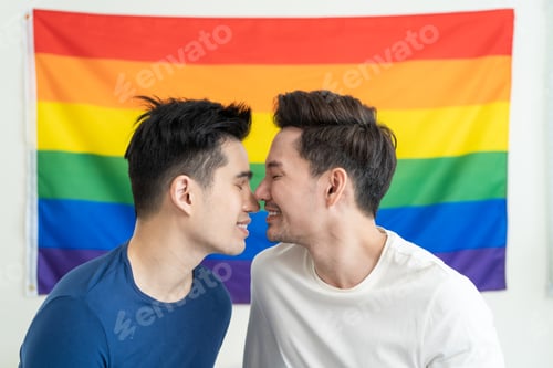 Preview: Portrait of Asian handsome man gay family holding LGBT flag and smile.