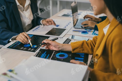 Preview: Businesswomen are working together, analyzing financial charts, reports, and data using laptops and