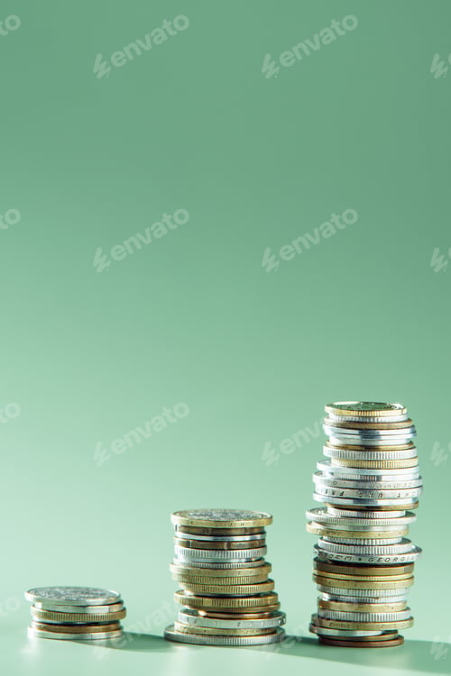 Preview: Side view of three stacks of different coins arranged in growing graph on green background. Money