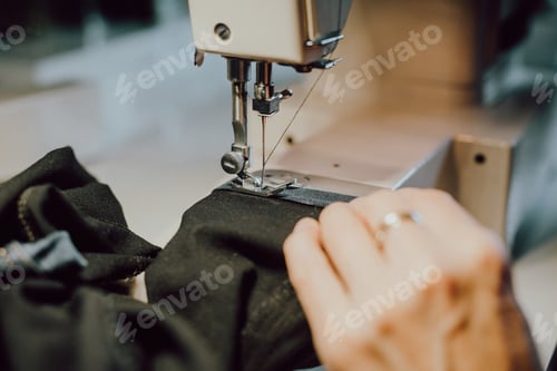 Preview: woman sews on the sewing machine