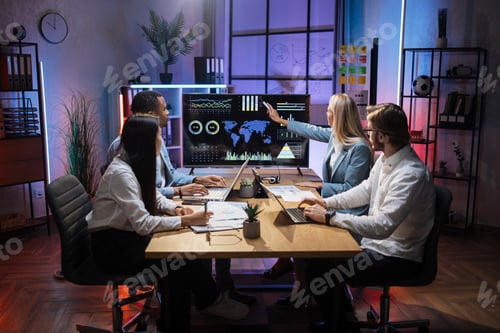 Preview: Multiracial partners discussing financial project at office