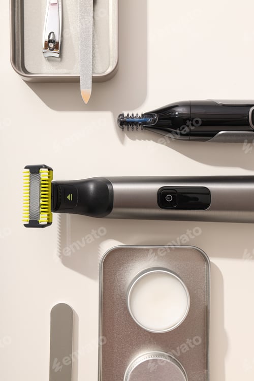 Preview: Men's electric shaving tools and manicure set on light background, top view