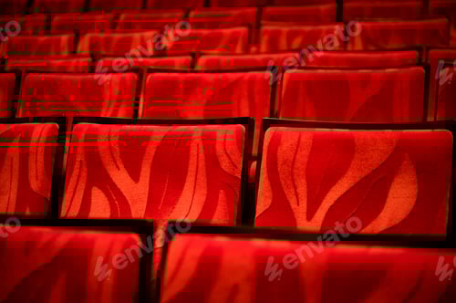 Preview: Closeup of empty red colored seats in a movie theatre with no person