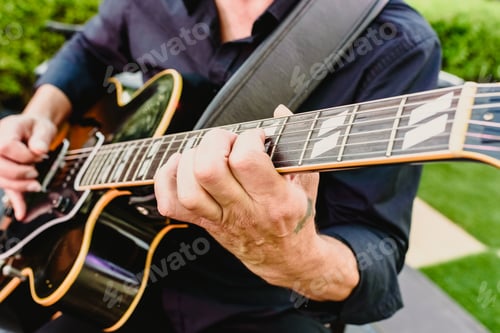 Preview: Guitarist playing his guitar outdoors