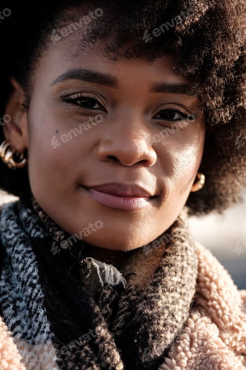 Preview: Close portrait of proud young black woman showing attitude outdoors.