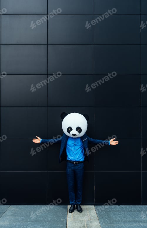Preview: Storytelling image of a business man wearing a giant panda head