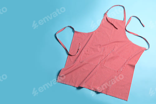 Preview: Striped apron on light blue background, top view. Space for text