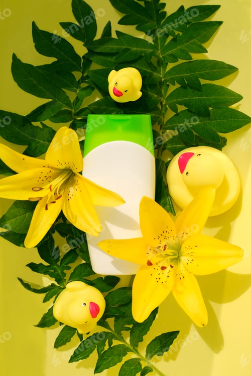 Preview: A means for bathing in a white bottle against the background of plants, lilies