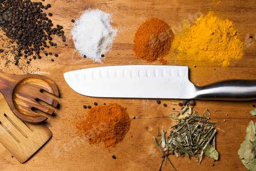 Preview: Spoon, knife and heap of spices on the table