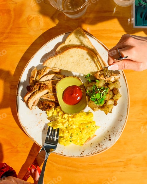 Preview: Top view of people eating delicious scrambled eggs with roasted chicken and potatoes