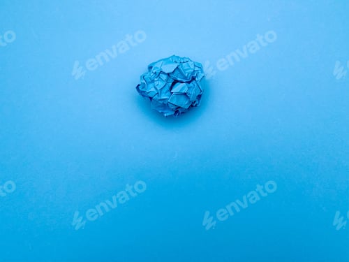 Preview: Successful idea concept, crumpled sheet of paper on blue background