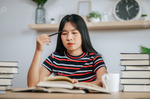 Preview: a young woman working in a book