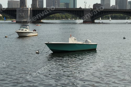Preview: Two skiff type boat sailing with a bridge in the background
